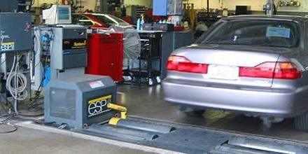 A used car undergoing a smog check on the dynamometer before a private-party sale in California